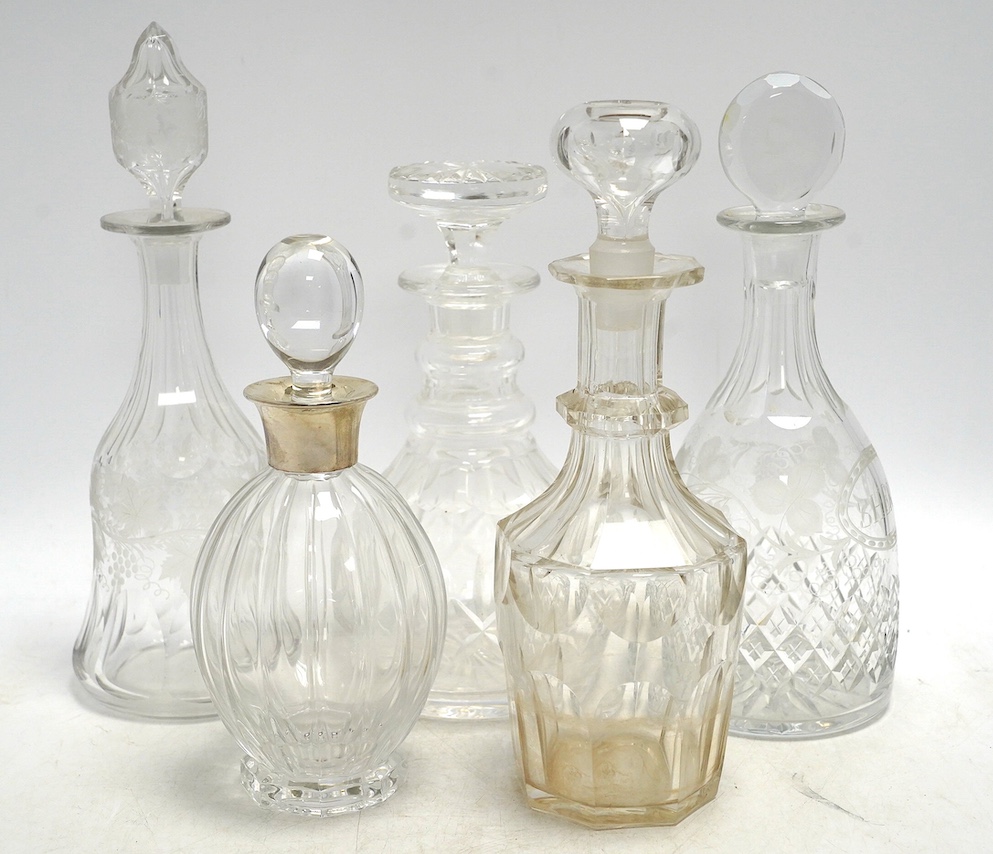Thirteen Victorian and later glass decanters including three silver mounted examples, tallest 30cm high. Condition - varies, mostly fair
